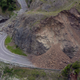 A landslide covers a section of state highway 1 near Kaikoura, New Zealand, Monday, Nov. 14, 2016, after a powerful earthquake. A powerful earthquake that rocked New Zealand on Monday triggered landslides and a small tsunami, cracked apart roads and homes, but largely spared the country the devastation it saw five years ago when a deadly earthquake struck the same region.